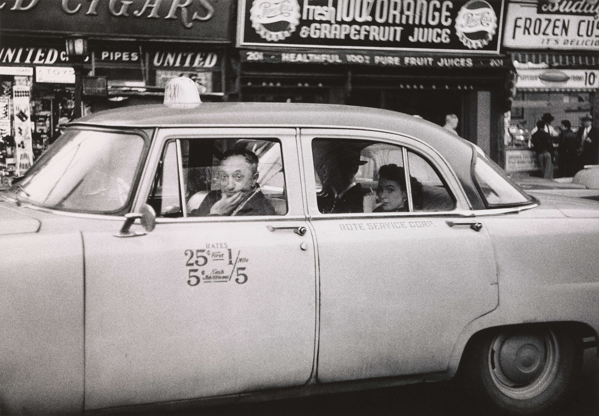 Taxicab driver at the wheel with two passengers, N.Y.C. 1956© The Estate of Diane Arbus, LLC. All Rights Reserved.