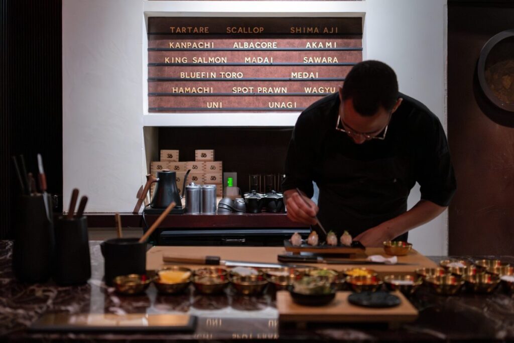 The chef and his assistants prepare dishes with seafood products, such as King Salmon, Bluefin Toro, Unagi, and Kanpachi/Photo: Brian Contreras