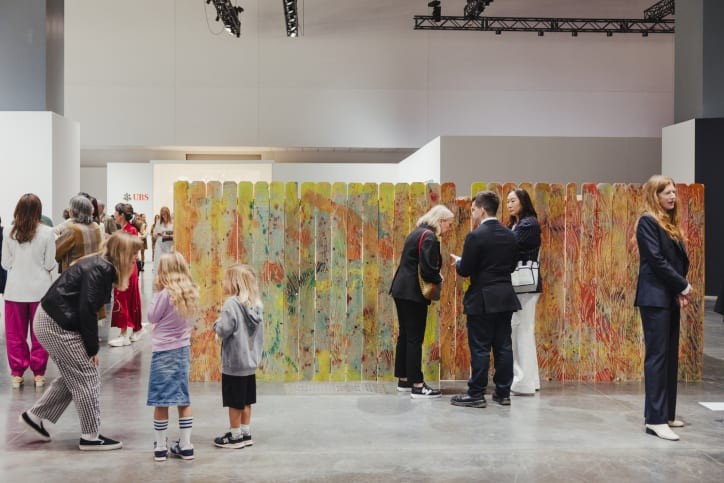 Visitors in front of a work by Saif Azzuz, presented by Nicelle Beauchene Gallery in the Meridians sector at Art Basel Miami Beach 2023.