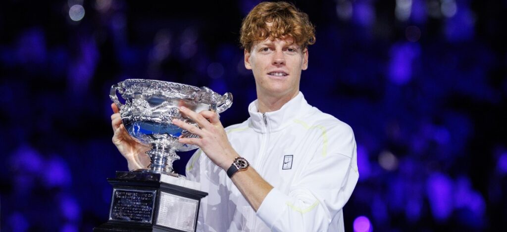 Jannik Sinner (ITA) lifts trophy following victory in the Mens Singles Final of the Australian Open at Melbourne Park / Photo via Rolex/Antoine Couvercelle