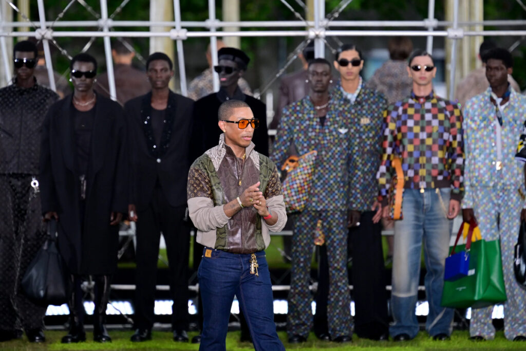 Creative director Pharrell Williams acknowledges the audience during the Louis Vuitton Menswear Spring/Summer 2025 / Photo via Kristy Sparow