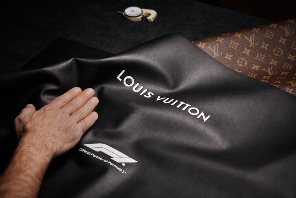 The trunk’s exterior features hand-painted Damier panels in black and white, a direct nod to Formula 1’s signature colors and the iconic checkered flag that signals victory at the finish line / Photo via Louis Vuitton