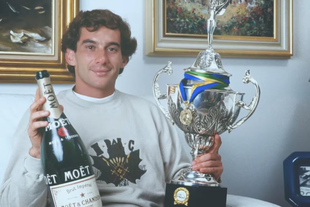 Ayrton Senna holding a Moet & Chandon / Photo via F1