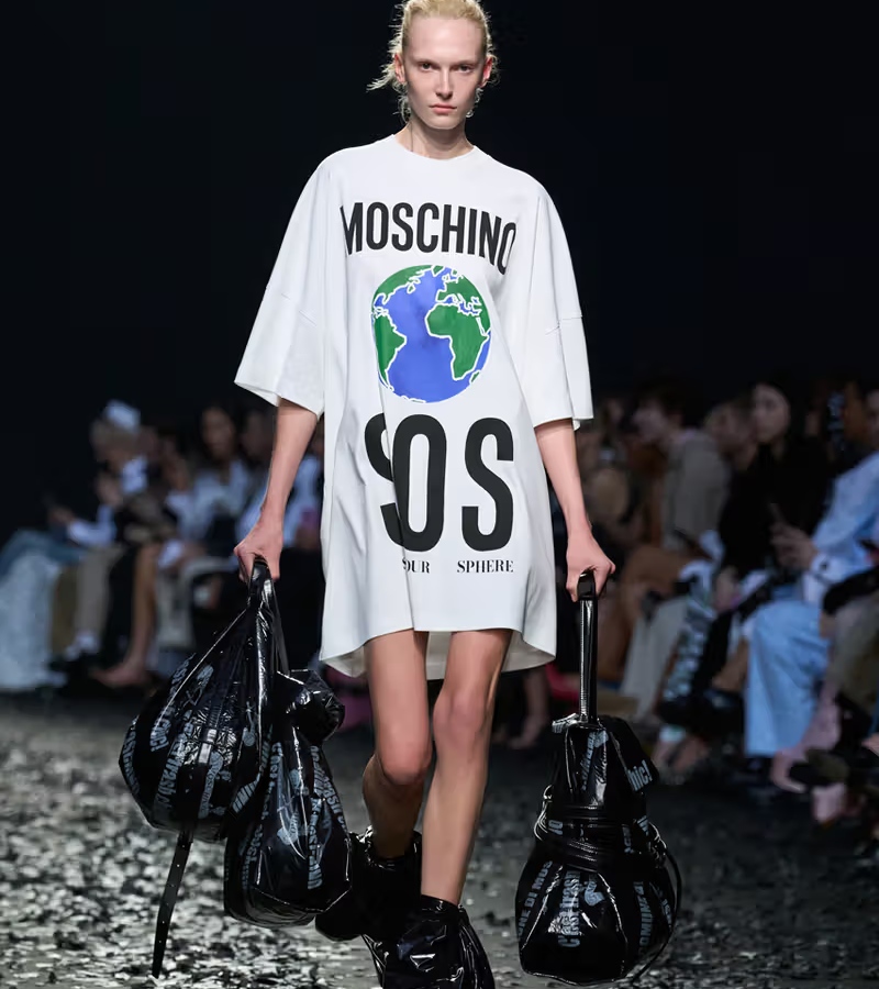 The final look—a minimalist oversized T-shirt dress emblazoned with an image of Earth and the phrase "MOSCHINO SOS" / Photo Moschino