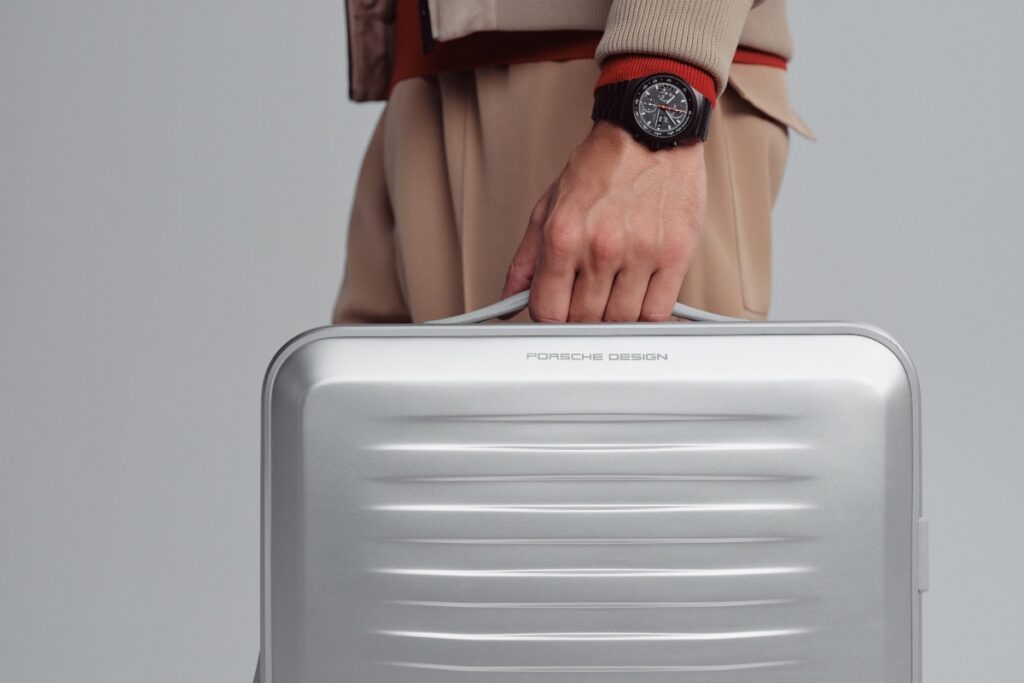 A collapsible tote bag, tucked inside, adds utility for shopping or separating worn items during travel. / Photo Porsche