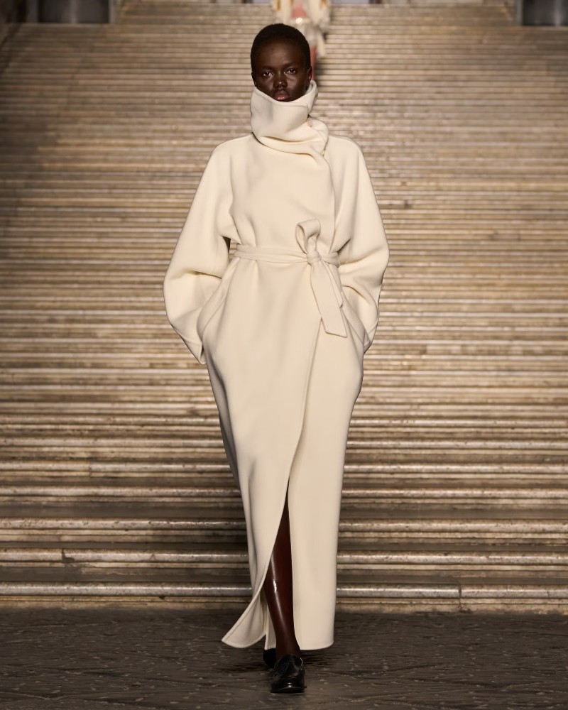 Max Mara amplified this with a set design that mirrored the coastal landscape, complete with terracotta accents and deep blue tones / Photo via Max Mara