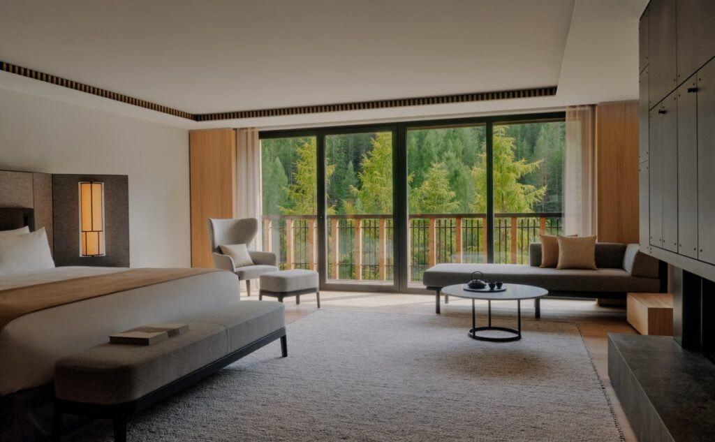 The 51 rooms and suites feature a calming fusion of timber, Dolomite stone, and subtle metallic accents. / Photo via AMAN