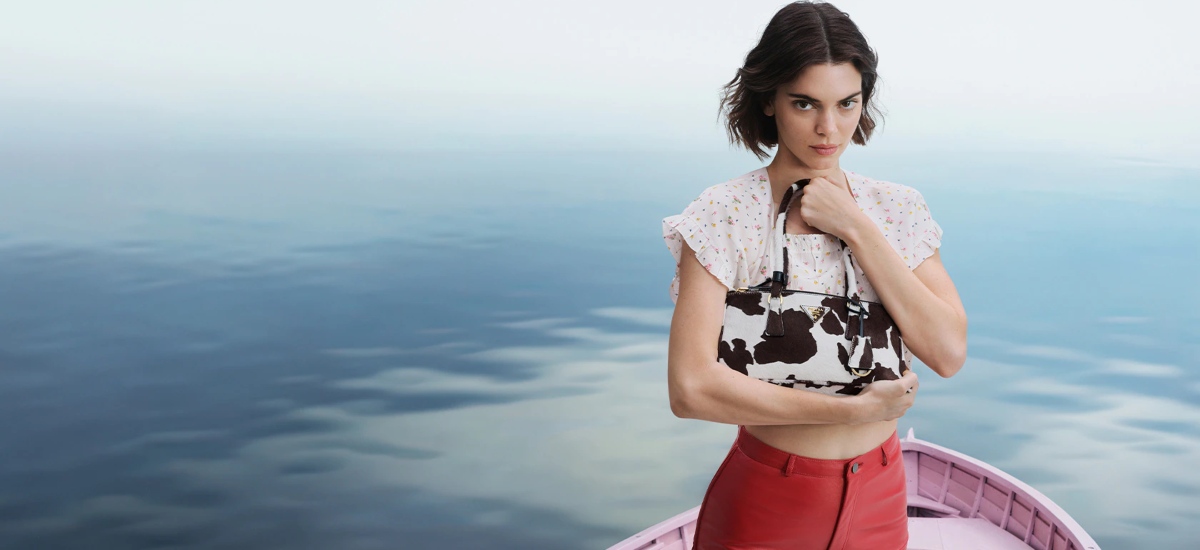 Models such as Kendall Jenner, Troye Sivan, and Hunter Schafer appear seated quietly on traditional gozzo boats. / Photo Prada