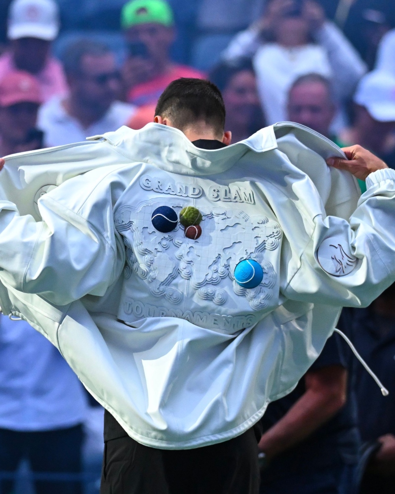 According to leading fashion houses, under the creative vision of Pelagia, a one-of-a-kind Lacoste jacket was crafted in tribute to Novak Djokovic / Photo via Lacoste