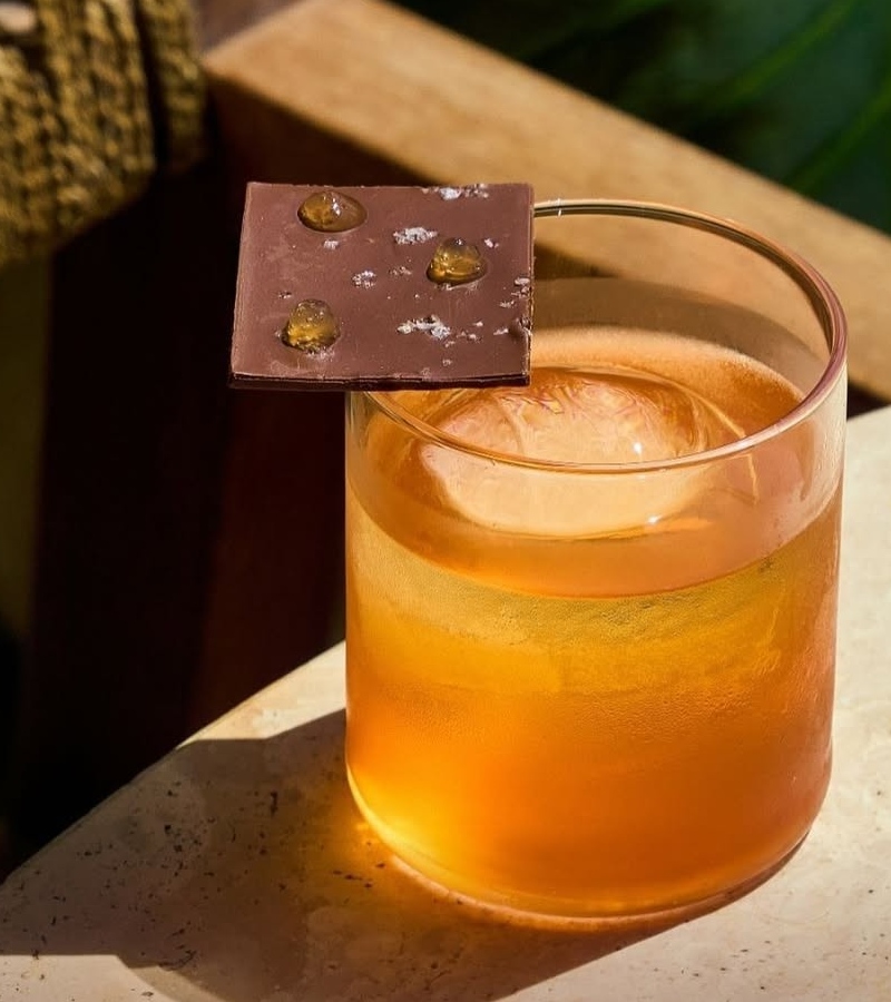 Bombay Sapphire, Campari, and Dolin Dry Vermouth are elevated through a passionfruit-and-milk wash, giving the cocktail silkiness and depth / Photo Claudie