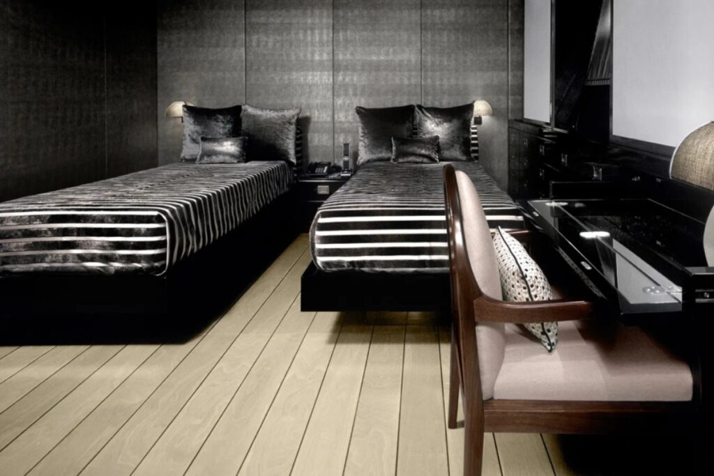 Interiors designed by Armani Casa, with custom furniture, subtle wood tones, natural materials, marble bathrooms, and lacquered walls echoing the hull colours. / Photo via Armani