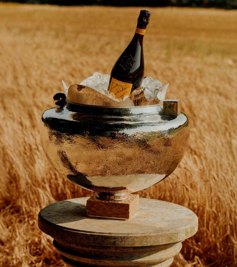 The Jacquemus x Veuve Clicquot collection relies heavily on symbolic design choices. The champagne’s iconic yellow, first trademarked in 1877, becomes a central motif. / Photo Veuve Clicquot