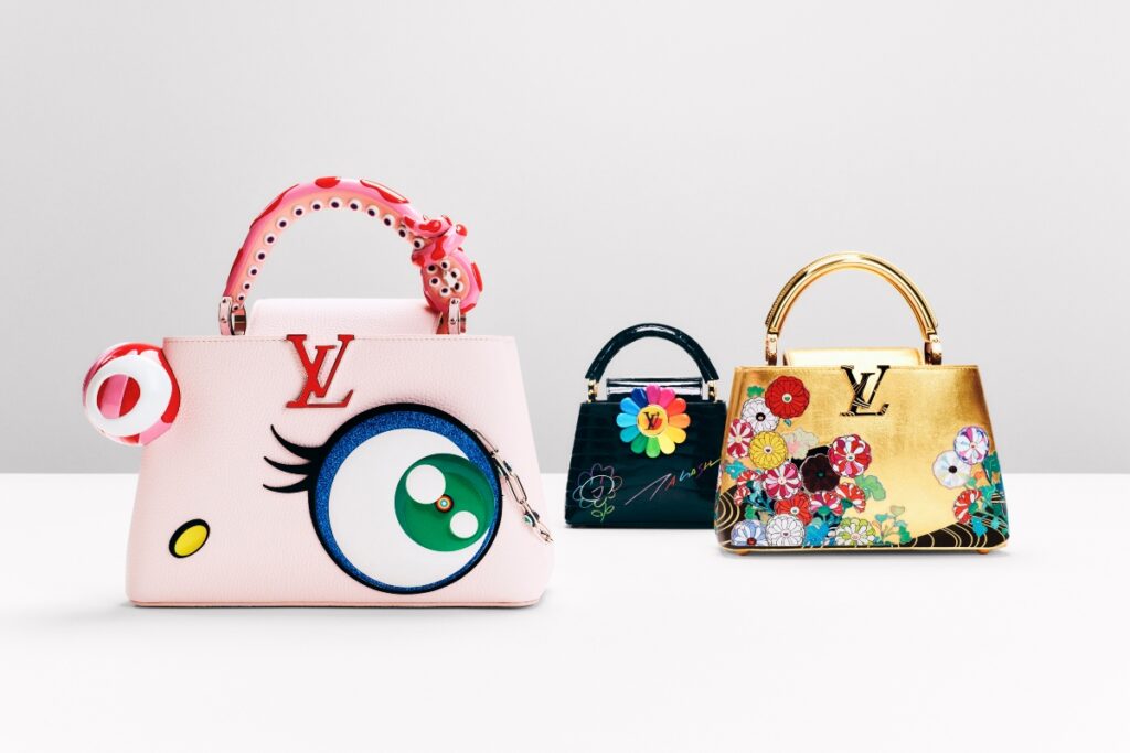 The Capucines EW Rainbow reinterprets the bag’s structure through Murakami’s legendary Rainbow Flower motif, a symbol of optimism rendered in a prism of color / Photo Louis Vuitton