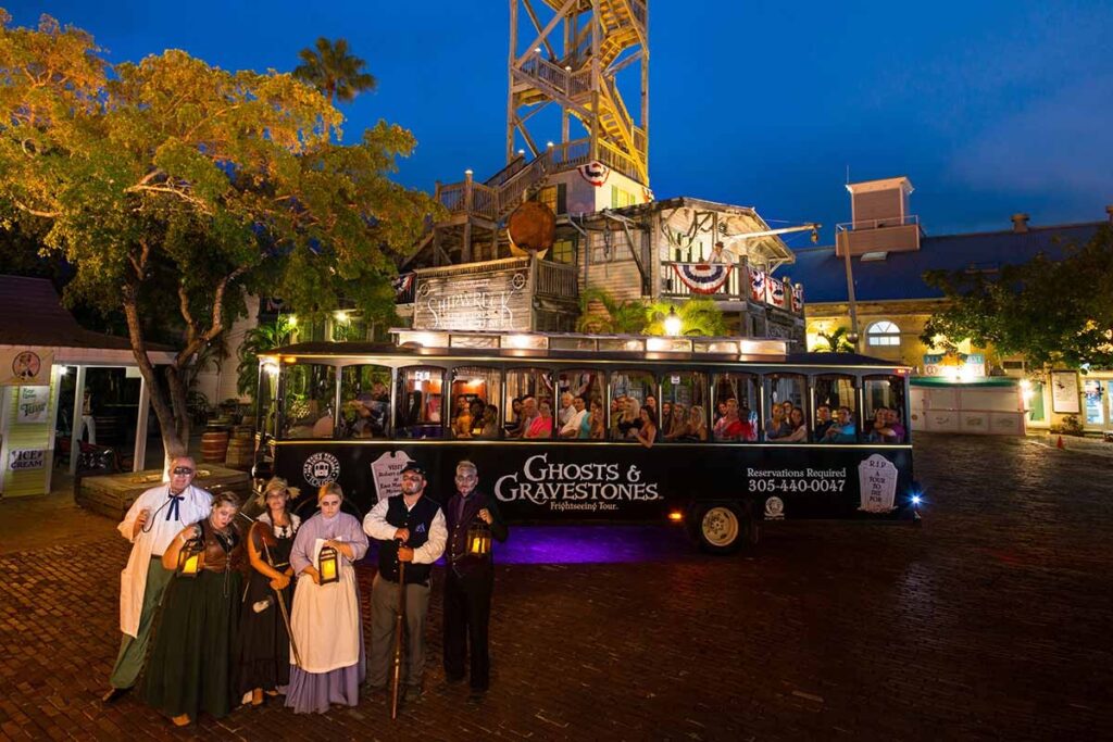 Hop aboard the “Trolley of the Doomed” for the famous Ghost & Gravestone Tour, where guides dressed as 19th-century undertakers recount chilling tales of haunted mansions / Photo via Key West Ghost & Gravestone