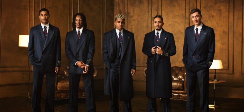 FC Barcelona’s blaugrana colors inspire the collection and include navy overcoats, pinstripe suits, and personalized accessories. / Photo via Amiri