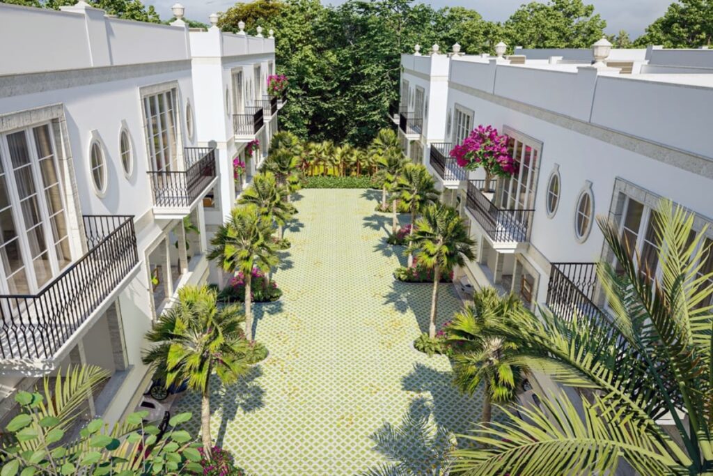 Covered terraces extend the living experience beyond interior walls. Coral stone flooring grounds the space with natural texture. / Photo Via Veneto